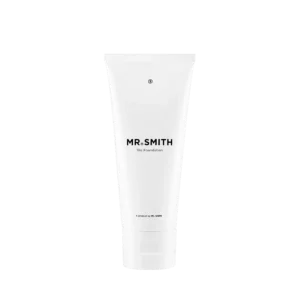 Witte tube van het haarverzorgingsproduct Mr. Smith The Foundation tegen een zwarte achtergrond.