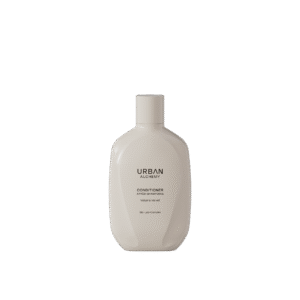Beige flacon van Urban Alchemy Volume Velvet conditioner met zwarte opdruk.