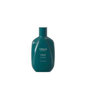Donkergroene fles Urban Alchemy Moisture Mane shampoo met witte opdruk op een zwarte achtergrond.